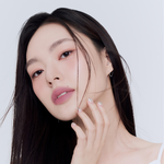 Model wearing Muzigae Mansion Objet Water Lip Tint in Posh, demonstrating the shade in natural lighting