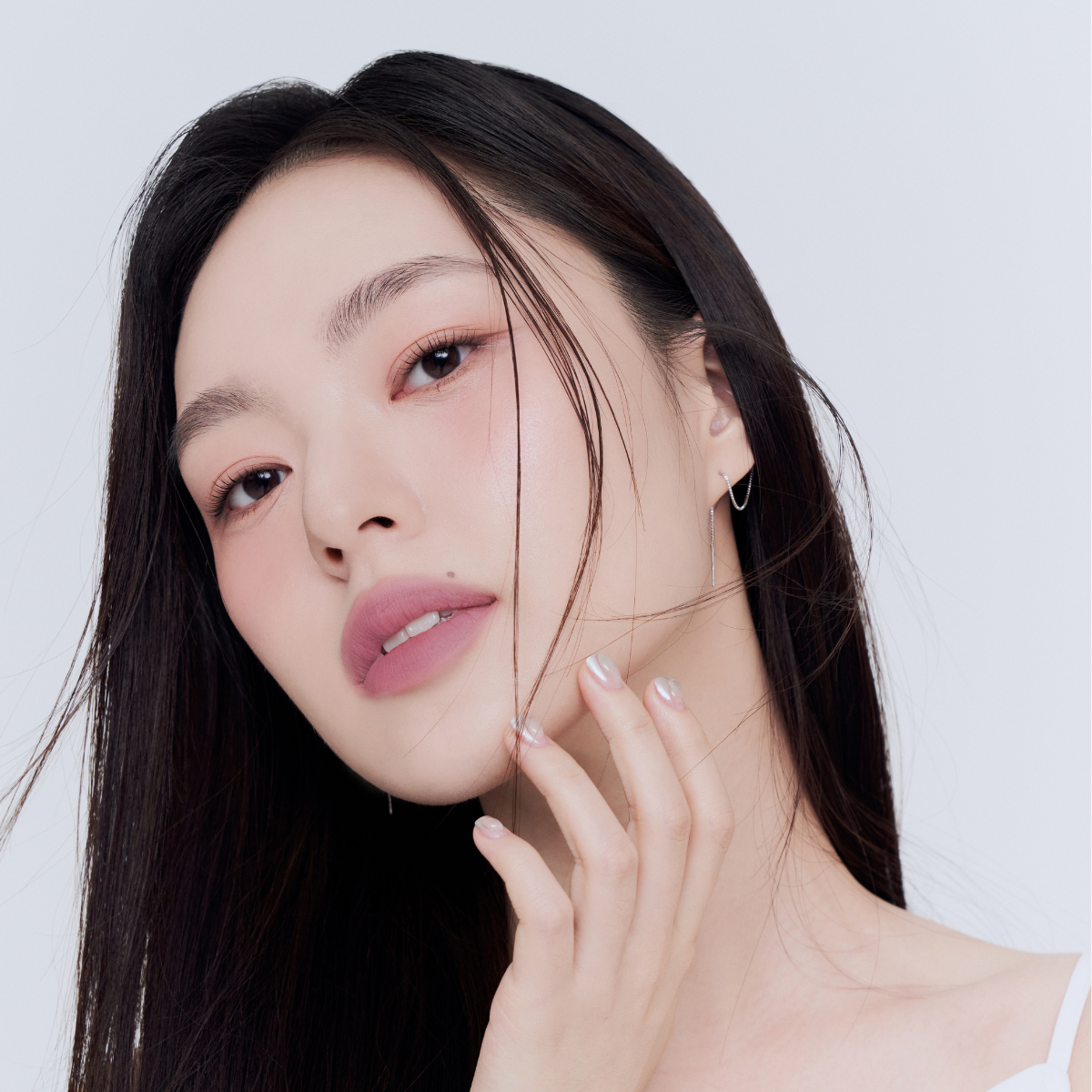 Model wearing Muzigae Mansion Objet Water Lip Tint in Posh, demonstrating the shade in natural lighting