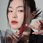 Model wearing Muzigae Mansion Objet Liquid Lip Tint in Affection 004, demonstrating the shade in natural lighting