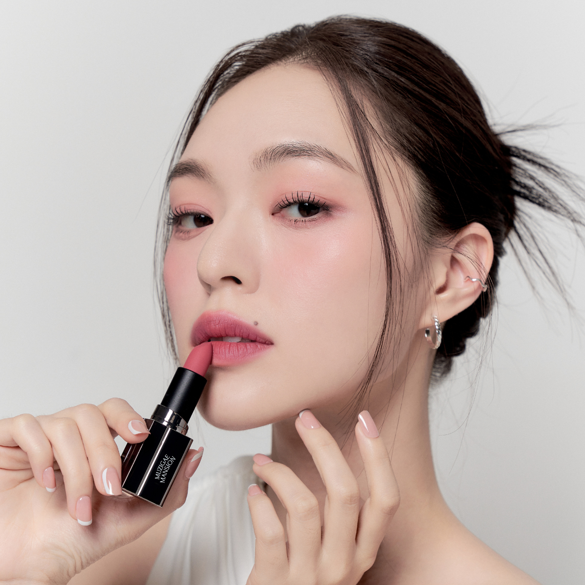 Model wearing Muzigae Mansion Moodwear Blur Semi-Matte Lipstick in 006 Ruffle, demonstrating the shade in natural lighting