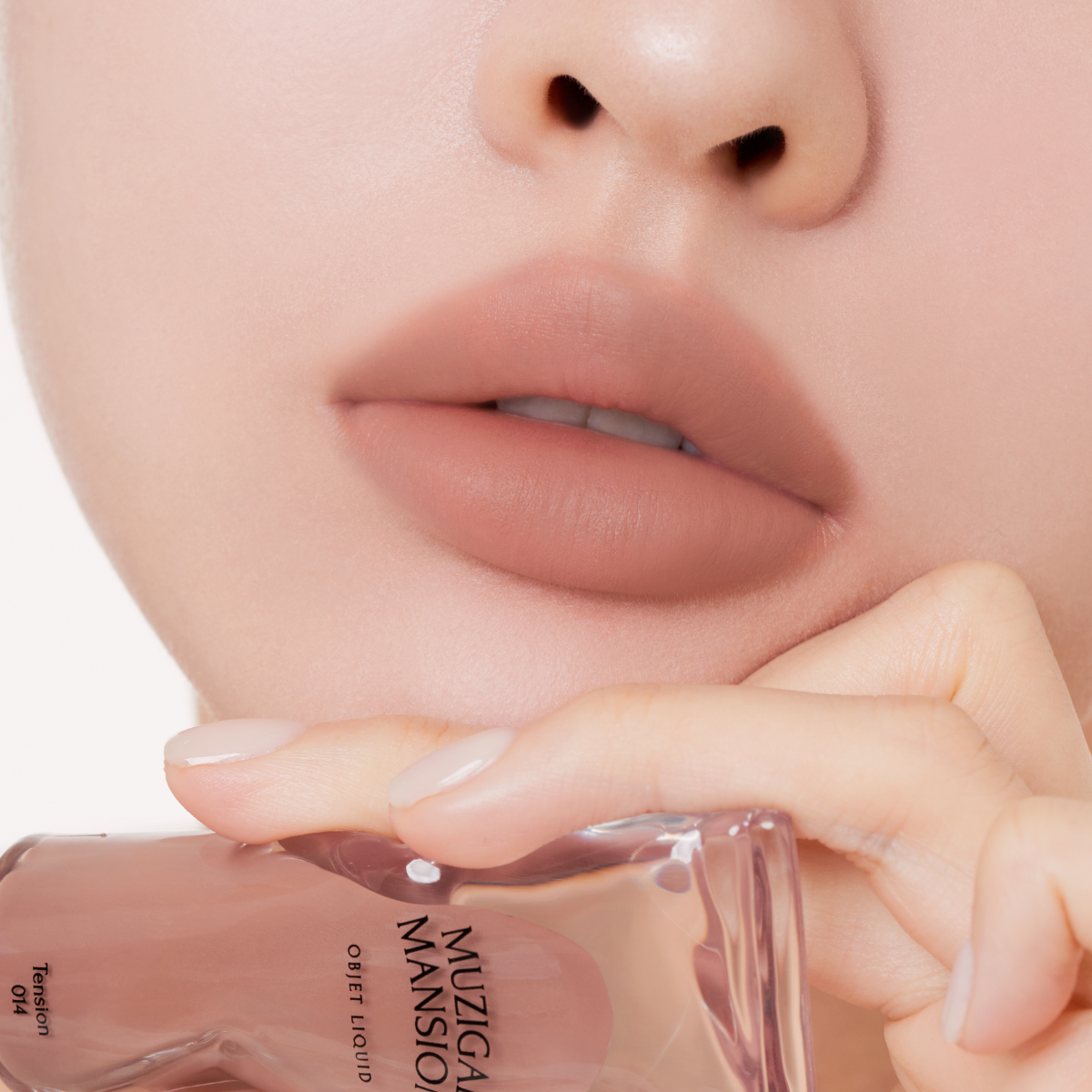 Muziage Mansion Objet Liquid Lip Tint in Tension 014 applied on lips, showing smooth matte finish